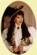 Woman in vintage attire with a hat and brooch.