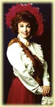 Woman in vintage attire with a red bonnet and braid.