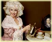 Woman in vintage attire pouring tea elegantly.